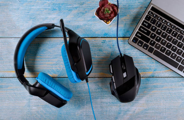 istock Computer gamer devices, modern mouse, headphones and keyboard with gaming accessories on table 1194154345