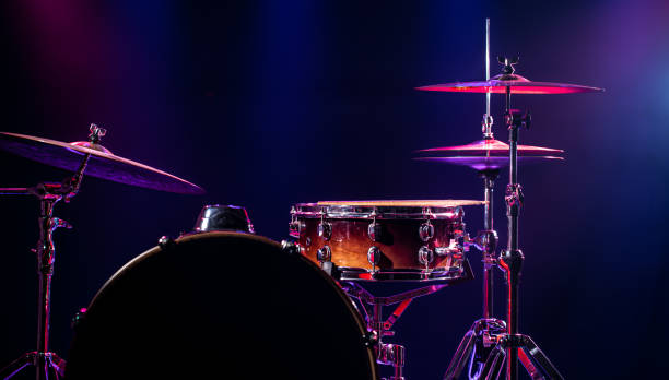 istock Drums and drum set. Beautiful blue and red background, with rays of light. Beautiful special effects of smoke and lighting. Musical instrument. Close-up photo. 1194155486