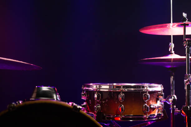 istock Drums and drum set. Beautiful blue and red background, with rays of light. Beautiful special effects of smoke and lighting. Musical instrument. Close-up photo. 1194155491