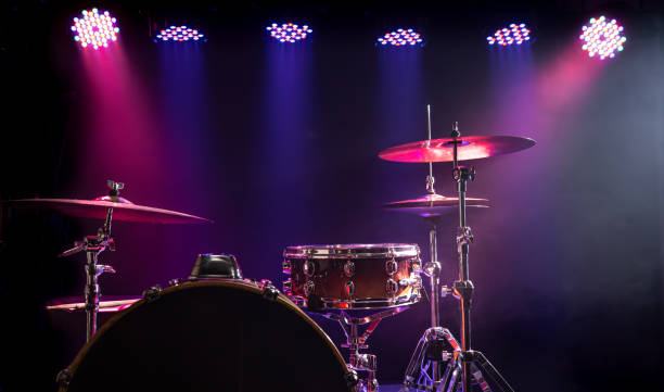 istock Drums and drum set. Beautiful blue and red background, with rays of light. Beautiful special effects of smoke and lighting. Musical instrument. Close-up photo. 1194155492
