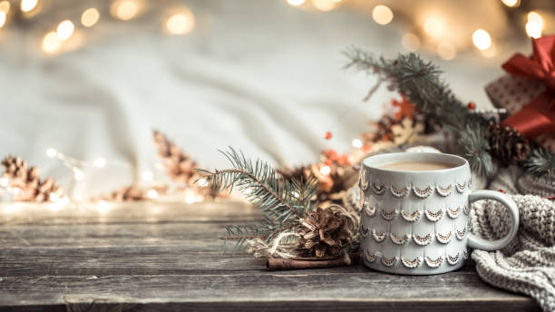 Festive background with Cup on wooden background with lights.