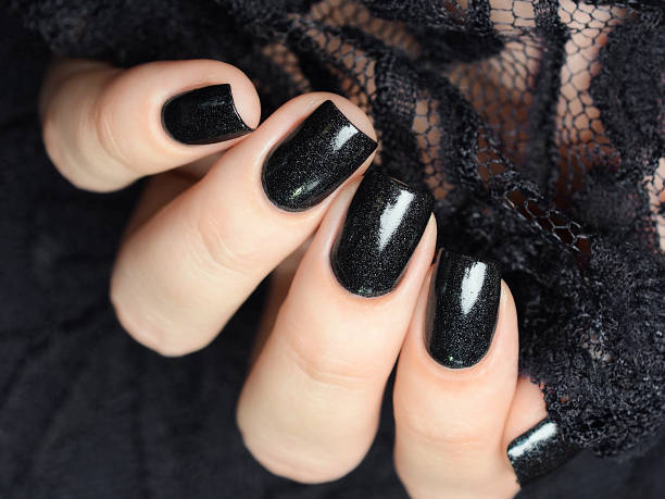 istock dark blue manicure on a background of black lace 1194156622