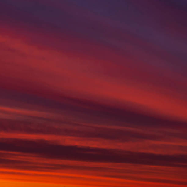 istock shiny orange sun light in sky with clouds 1194163339