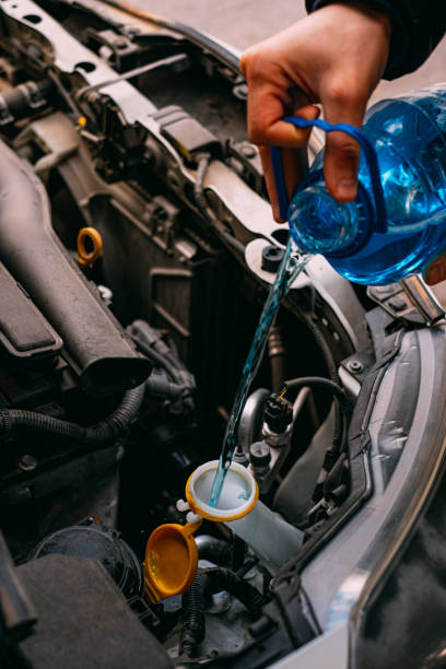 istock Man Putting Antifreeze in His Car 1194164106