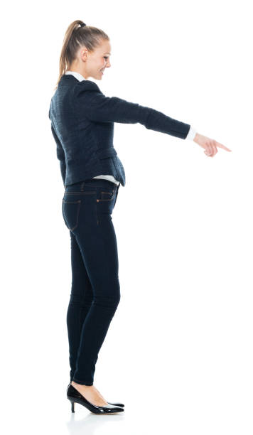 istock Side view / profile view / looking down / full length / front view / looking at camera / one person of 20-29 years old adult beautiful brown hair / ponytail caucasian female / young women business person / businesswoman standing who is pointing 1194164633
