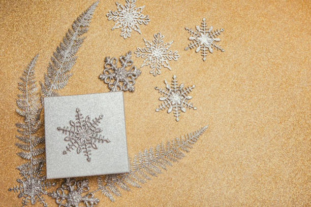 istock Christmas gift box and silver decorations on golden background. 1194164784