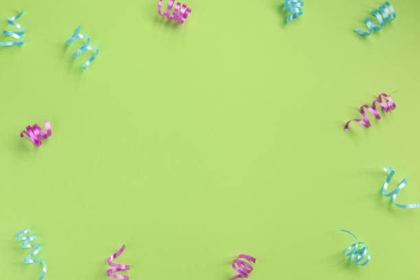 istock Colorful serpentine  on green  background. Celebration concept .Flat lay, top view, copy space. 1194166880