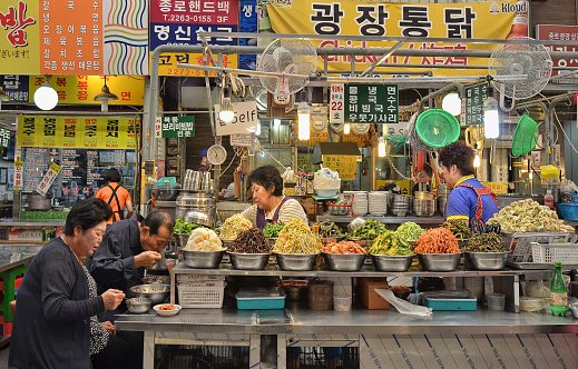 People eating in a food market in Seoul (South Korea