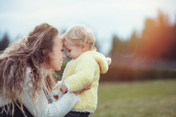 istock cold weather mother hugging son 1194170545