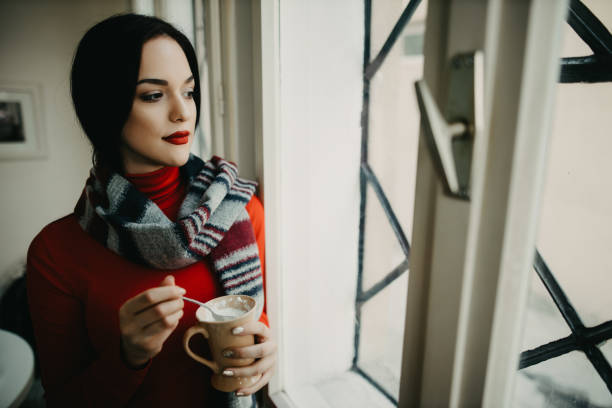 istock Sad sensual lady standing by the window 1194172239
