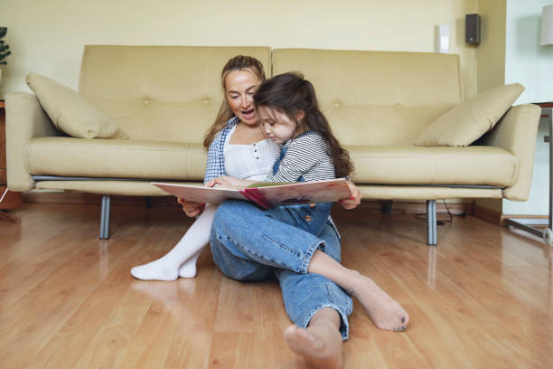 istock Mother is Reading a Book to her Daughter 1194174871