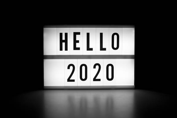 istock Hello 2020 - text on a display lightbox in the dark. New year concept 1194177040