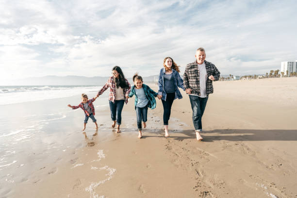 istock Family running on the beach 1194177278