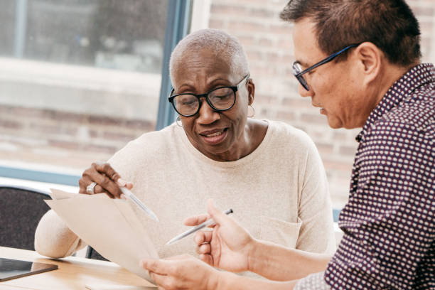 istock Senior woman signing a will 1194177298