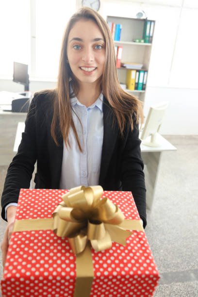 istock Young businesswoman holding a gift 1194177351