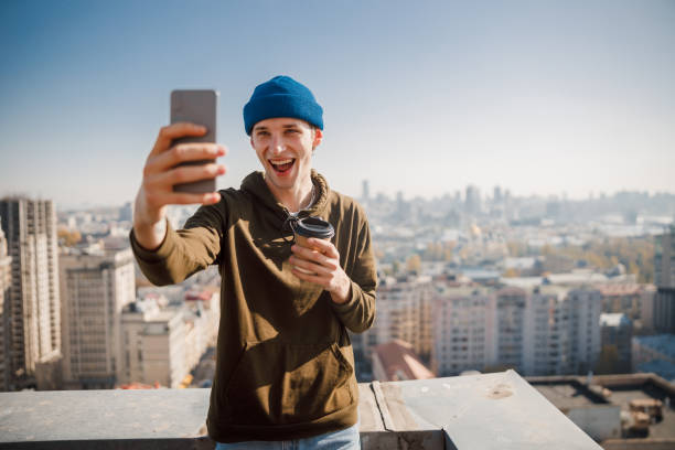 istock Happy young guy is making selfie outdoors 1194179015