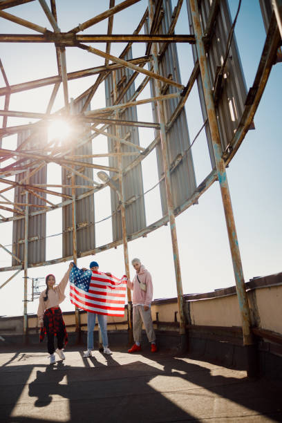Friends are holding flag on the roof