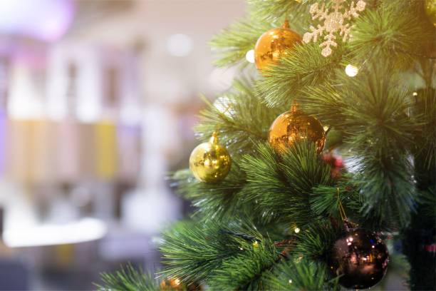 istock Golden ball on Christmas tree in house 1194181186