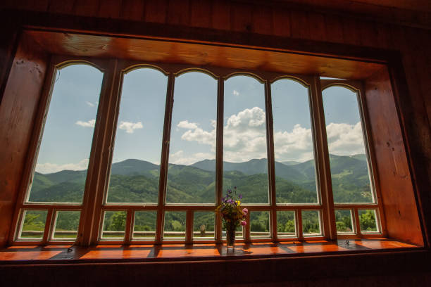 istock Summer field and mountains seen through the window 1194182729