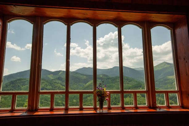 istock Summer field and mountains seen through the window 1194182731