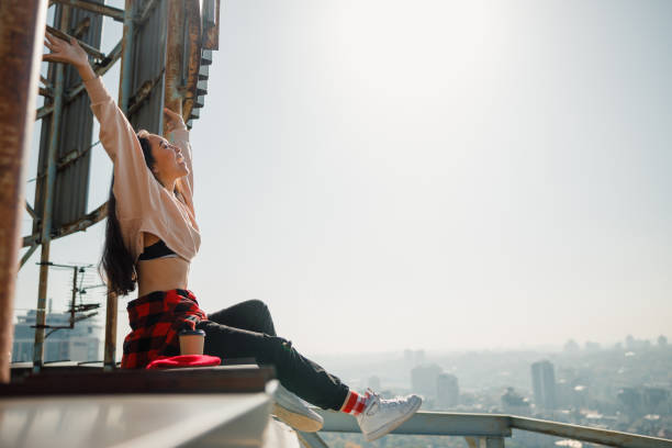 istock Happy attractive lady looking up on rooftop 1194184854