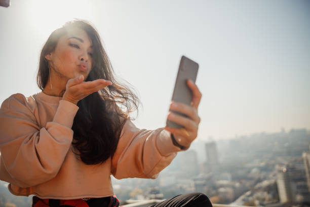 istock Pretty young lady making selfie on the roof 1194184870