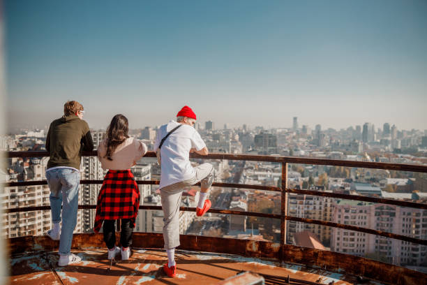 istock Young friends spending time on the roof 1194184898