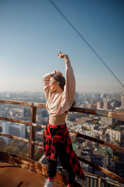 istock Happy pretty lady is relaxing on roof 1194186146