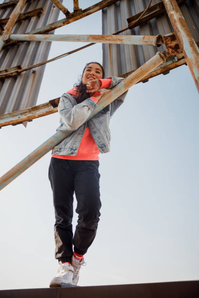 istock Beautiful smiling woman is standing on roof 1194186184