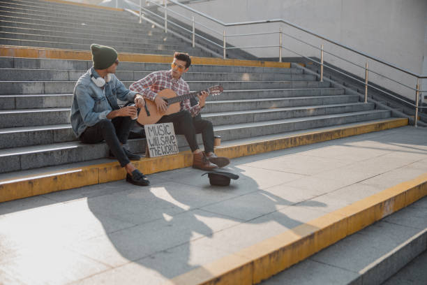 istock Two friends chatting with each other on the steps 1194190609