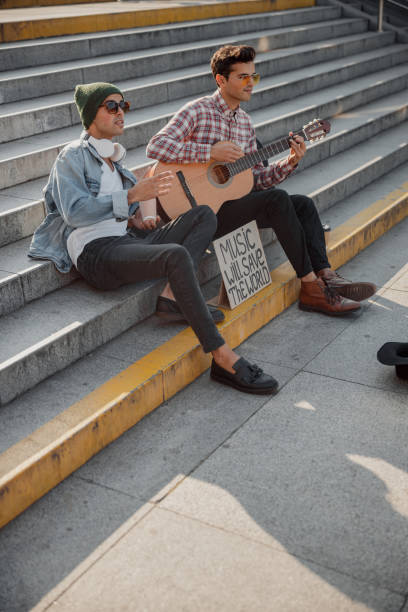 istock Guys sitting on the steps and looking in front of them 1194190629