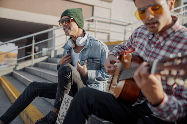 istock Two musicians sitting on the steps in the city 1194190634
