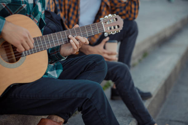 istock Male hands are holding giutar on steps 1194190639