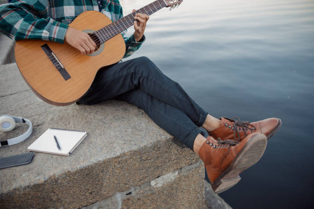 istock Young guy with his instrument near river 1194191697