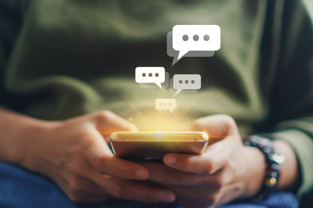istock Women hand using smartphone typing, chatting conversation in chat box icons pop up. Social media maketing technology concept.Vintage soft color tone background. 1194192005