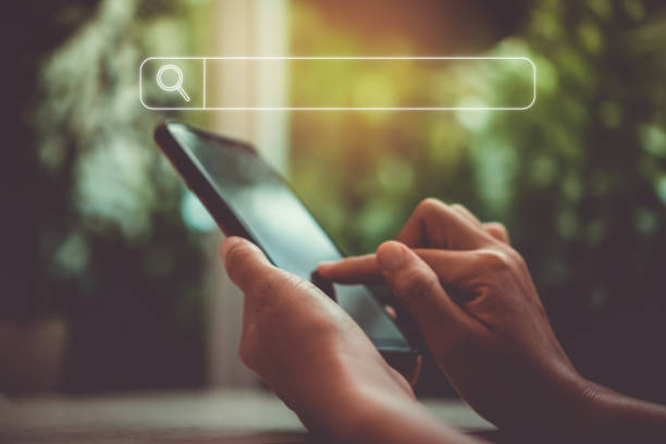 istock People hand using mobile phone or smartphone searching for information in internet online society web with search box icon and copyspace. 1194192010