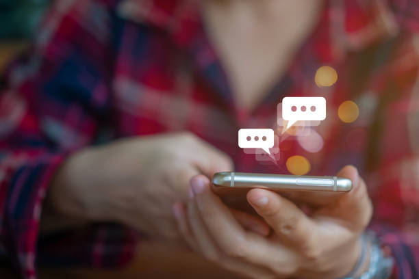 istock Women hand using smartphone typing, chatting conversation in chat box icons pop up. Social media maketing technology concept.Vintage soft color tone background. 1194192167