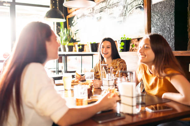 istock Female friends talking in a cafe 1194192781