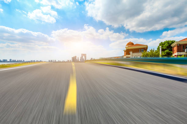 Motion blur road and Suzhou city skyline on a sunny day.