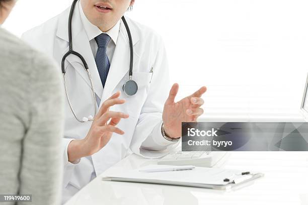 Doctor Explaining Something To A Patient Stock Photo - Download Image Now - Adult, Color Image, Doctor