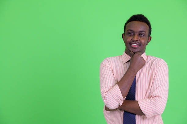 istock Happy young African businessman thinking and looking up 1194196078