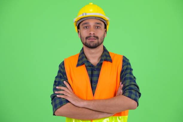 istock Young bearded Persian man construction worker with arms crossed 1194196204