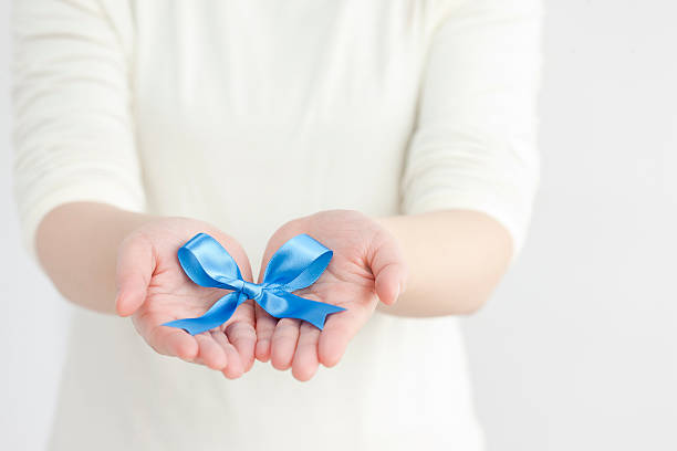istock Blue ribbon put on hand 119419688