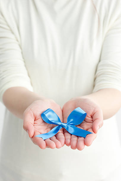 istock Blue ribbon put on hand 119419690