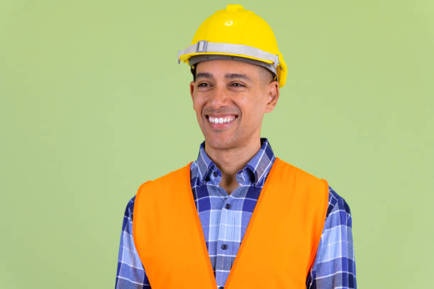 istock Face of happy multi ethnic man construction worker thinking 1194198142