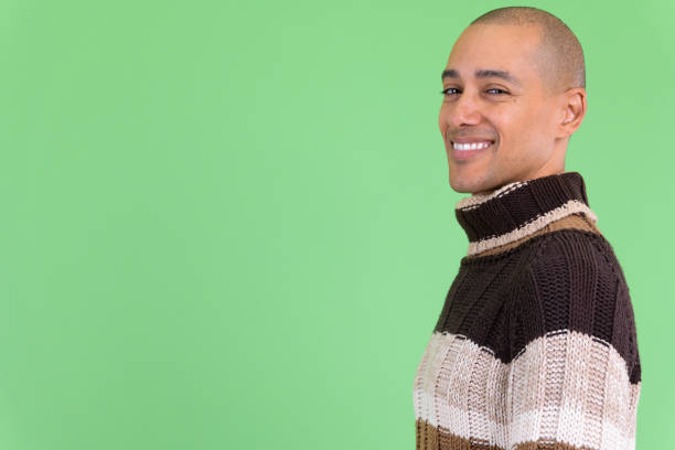 Portrait of a bald man on a background of a wooden wall