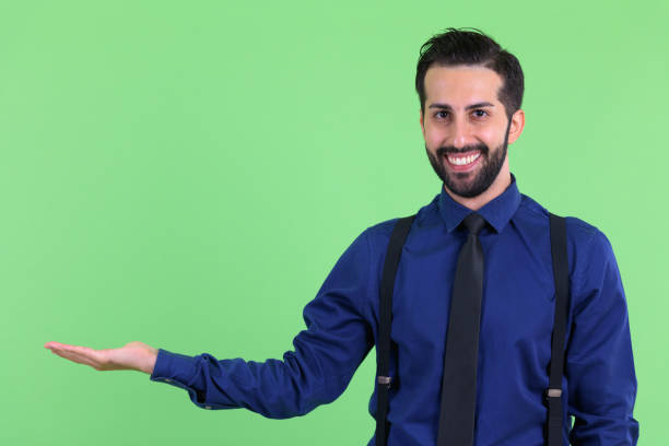 istock Young happy bearded Persian businessman showing something 1194199459