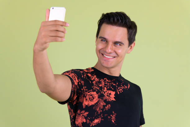 istock Portrait of young handsome man taking selfie 1194200105