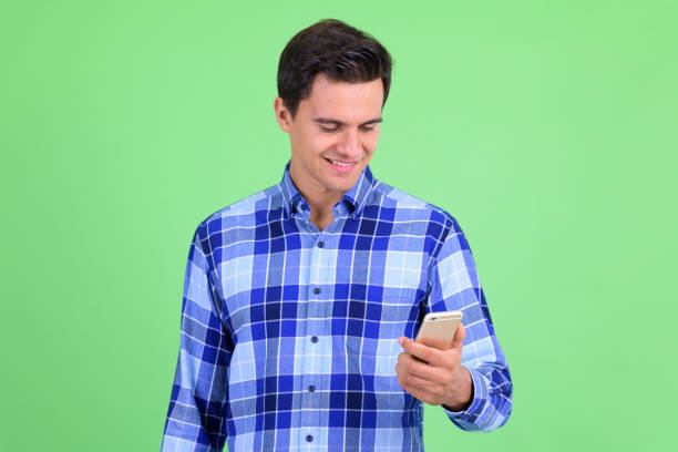 istock Happy young handsome hipster man using phone 1194200275