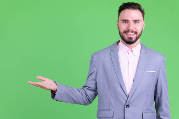 istock Happy young handsome bearded businessman showing something 1194202359